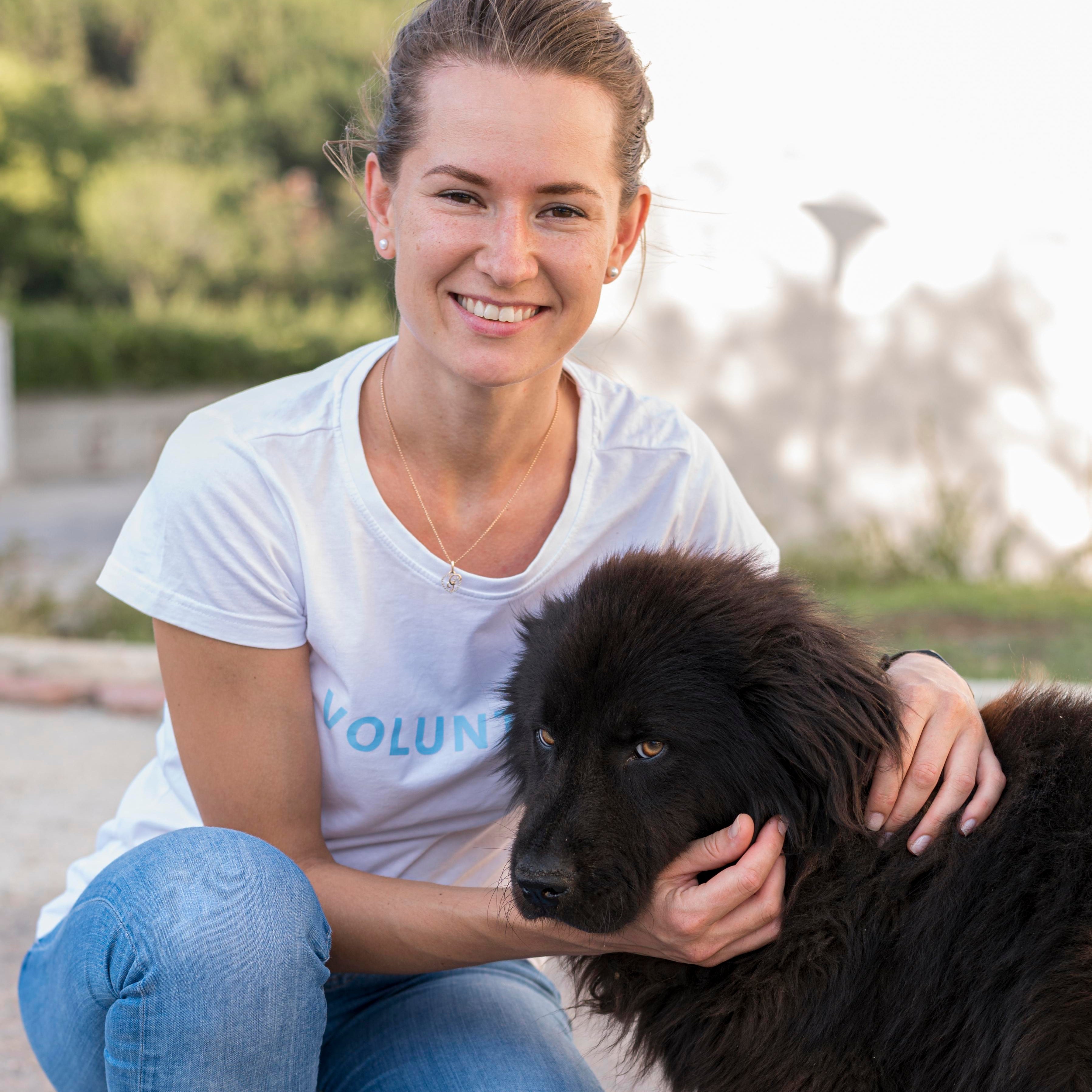 files/smiley-woman-posing-with-fluffy-black-dog-outdoors_1.jpg